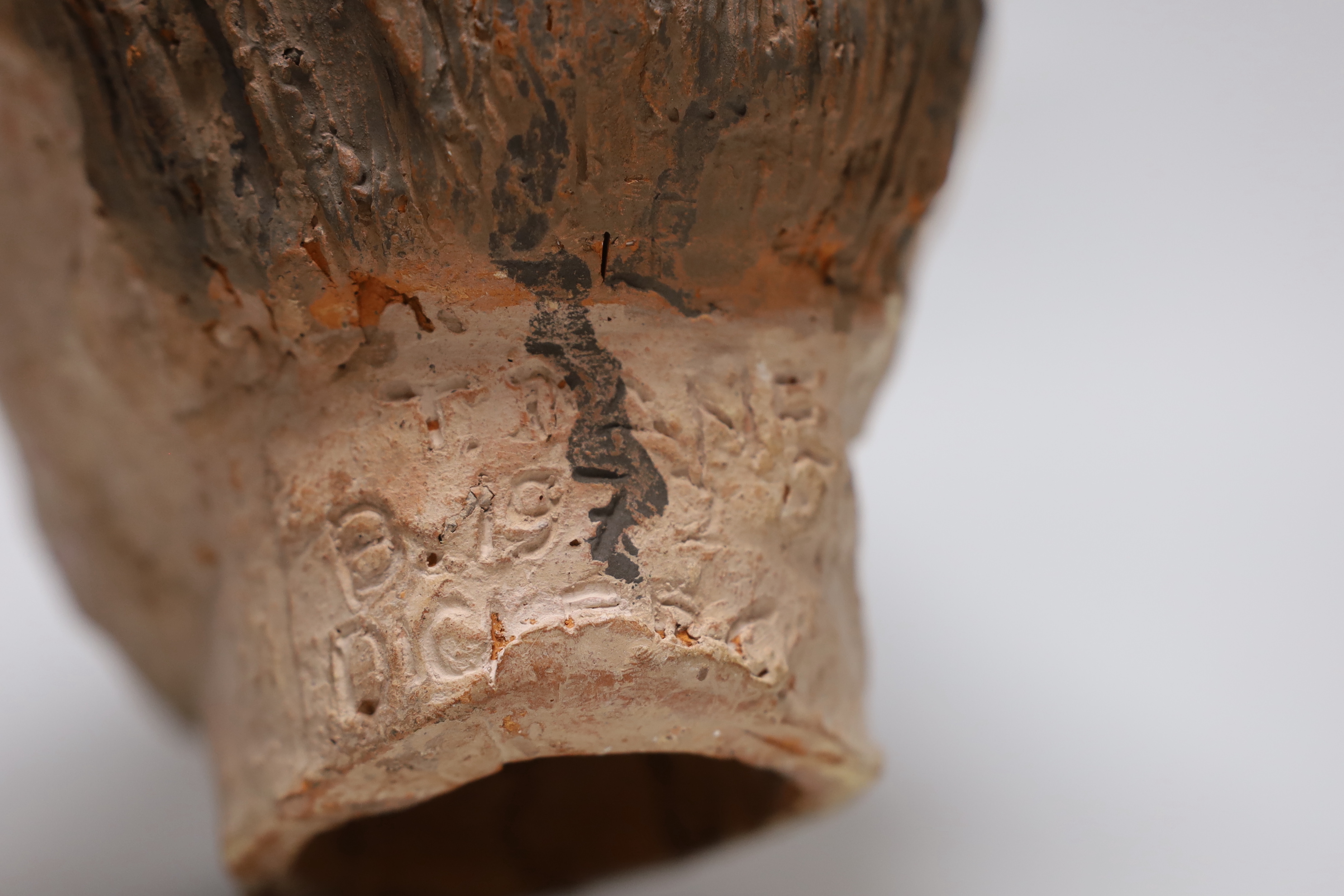 A terracotta bust of a boy, back of neck signed, 23cm